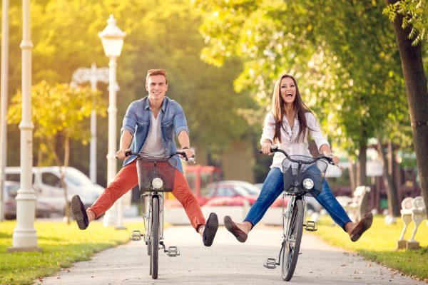 Happy,Funny,Young,Couple,Riding,On,Bicycle